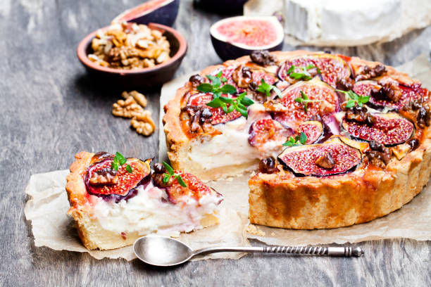 istock Delicious  tart with fresh figs and goat cheese on rustic wooden table 861634614