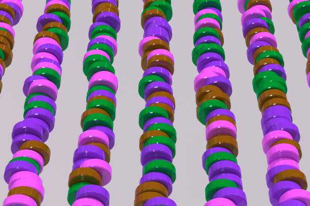 istock Pattern of brown, violet and green cylinder tablets on white background 861634758