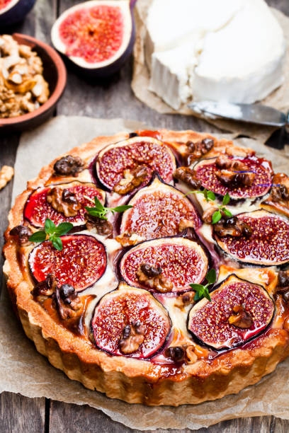istock Delicious  tart with fresh figs and goat cheese on rustic wooden table 861635072