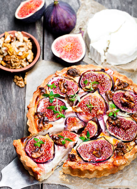 istock Delicious  tart with fresh figs and goat cheese on rustic wooden table 861635226