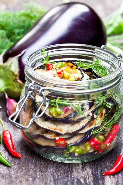 istock Grilled  sliced eggplant with chili in glass jar on rustic table. 861637538