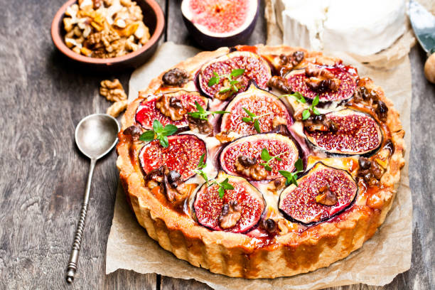 istock Delicious  tart with fresh figs and goat cheese on rustic wooden table 861637694