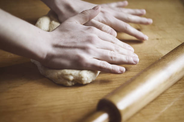 istock Woman kneading a dough on the table 861638784