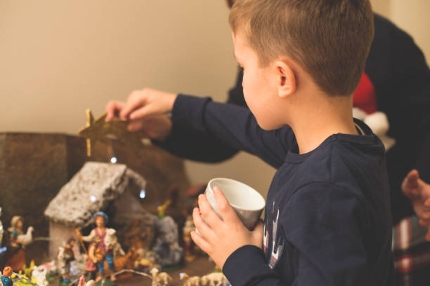 istock Christmas - Mother and son making crib 861641868