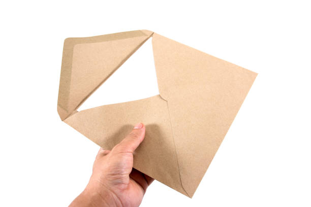 istock Brown document envelope and white paper with hand holding isolated on white background 861645252