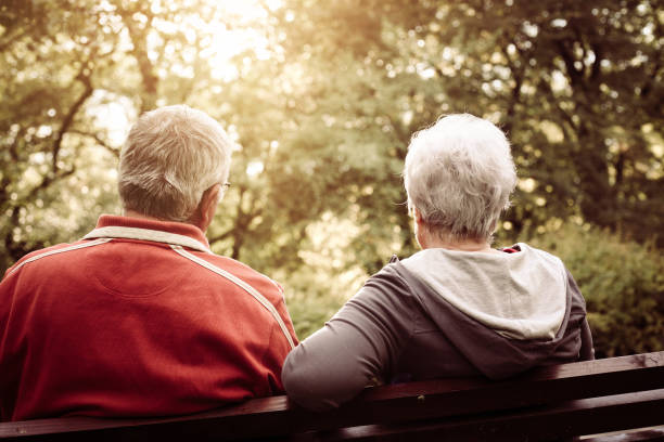 istock Senior couple sitting on bench after exercise. From back. 861648066