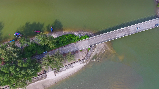 Aerial shot at tropical sea with long tail boat in south thailand