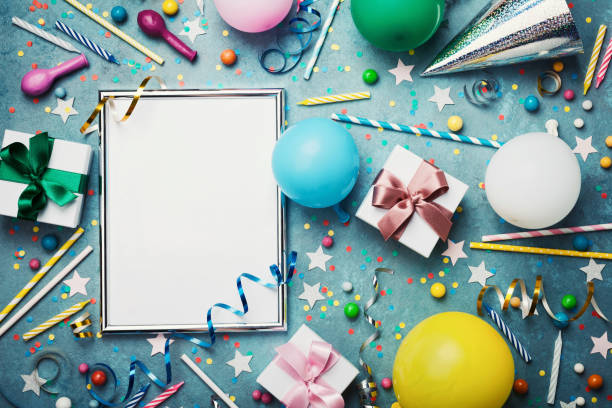 istock Party or birthday background. Silver frame with colorful balloon, gift box, carnival cap, confetti, candy and streamer. Flat lay. Holiday or festive mockup. 861655500