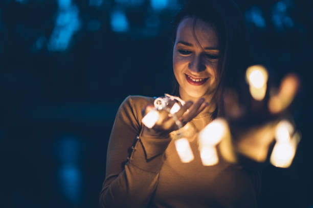 istock Beautiful young woman outdoors with lights 861658320