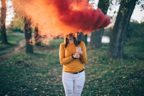 istock Woman with smoking umbrella at park 861658618