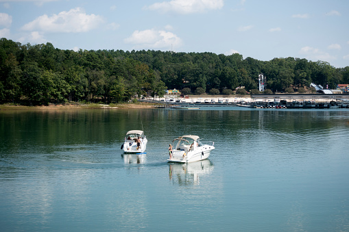 Buford, USA - September 16, 2017. A lady talking to a man on neighbouring boat on Lake Lanier around Lanier Islands in Buford, Georgia.