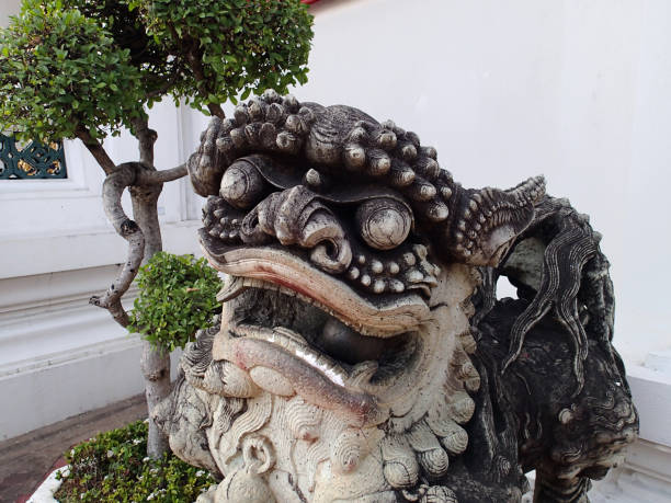 istock Stone figure of a Thai monster and a tree-bonsai 861661816