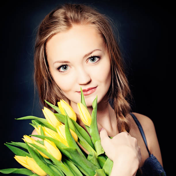 istock Cute Woman with Yellow Spring Flowers 861671248