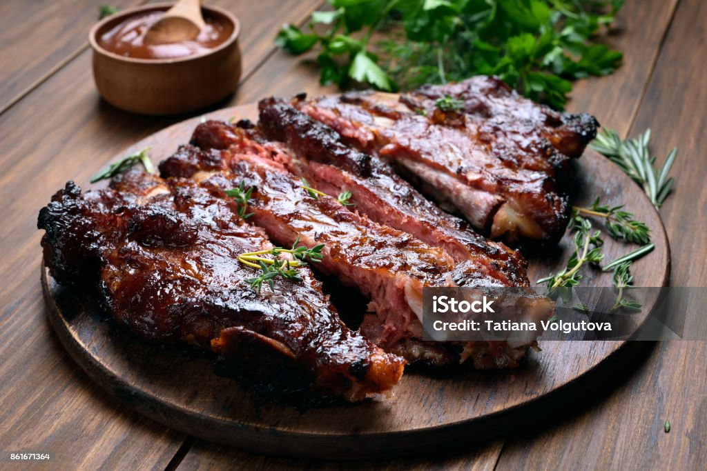 Barbecue pork ribs Grilled sliced barbecue pork ribs on wooden board Rib - Food Stock Photo