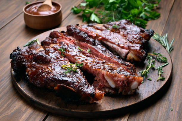 Barbecue pork ribs Grilled sliced barbecue pork ribs on wooden board barbecue pork stock pictures, royalty-free photos & images
