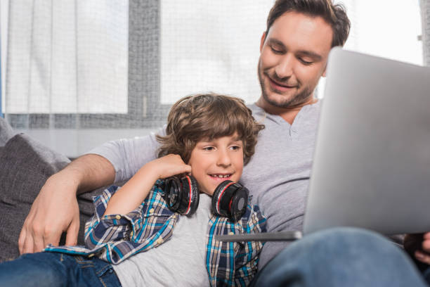 istock father and son with laptop 861671860