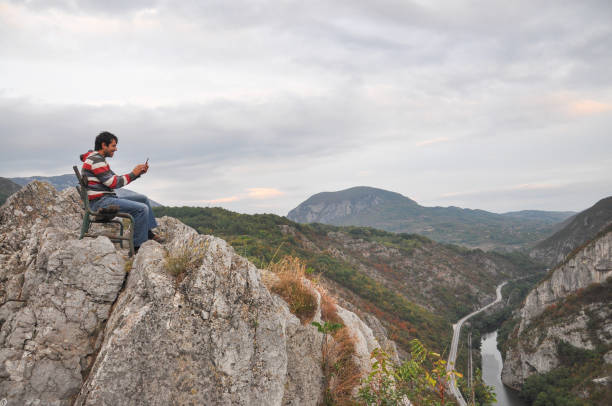 istock Man with phone on cliff taking photo. 861677754