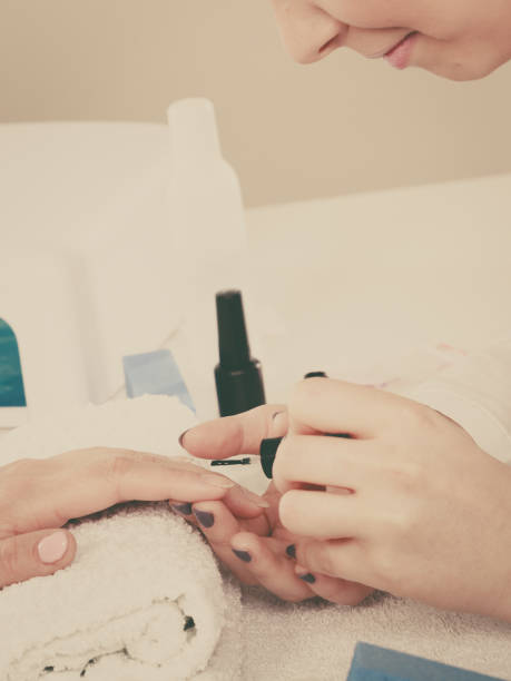 istock Woman in beauty salon getting manicure done. 861678538