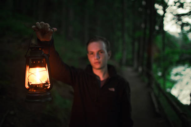 istock Man walking   in the forest with gas lantern 861681684