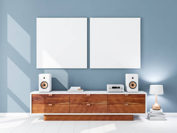 istock Two square white canvas Mockups hanging on the blue wall, hi fi audio micro system on bureau 861684056