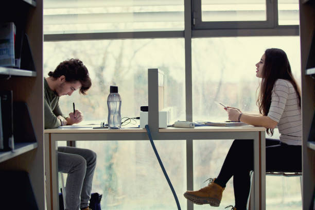 istock Young students sitting together in the library 861691032