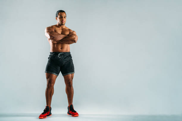 istock Studio shot of young bodybuilder standing over gray background 861692680