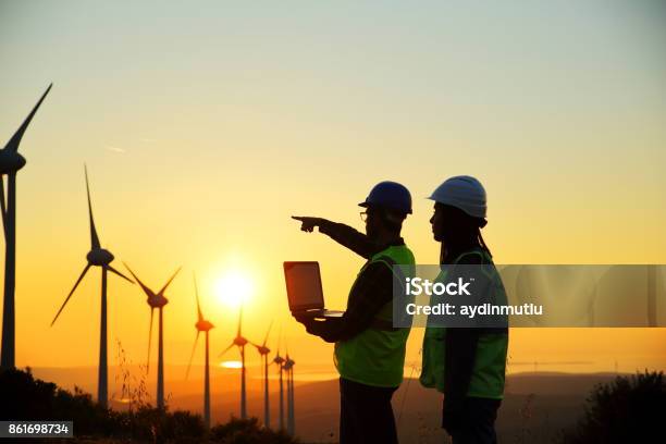 Windmills And Workers Stock Photo - Download Image Now - In Silhouette, Wind Turbine, Engineer
