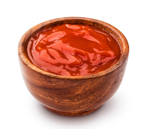 istock Ketchup in wooden bowl isolated on white background 861698754