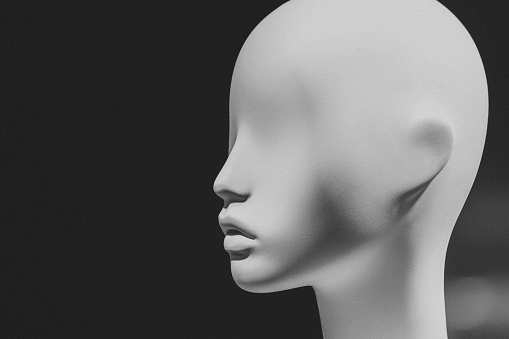 Black and white image of an eyeless mannequin.