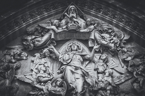Exterior sculptures above the Door of Assumption in the center of the west facade of Seville cathedral. Cardinal Cienfuegos y Jovellanos commissioned the artist Ricardo Bellver (1845-1924) to carve the relief of the Assumption over the door, it was executed between 1877 and 1898.