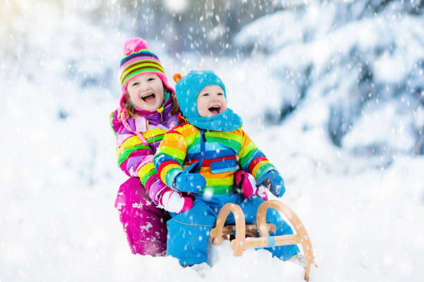 istock Kids on sleigh ride. Children sledding. Winter snow fun. 861706034