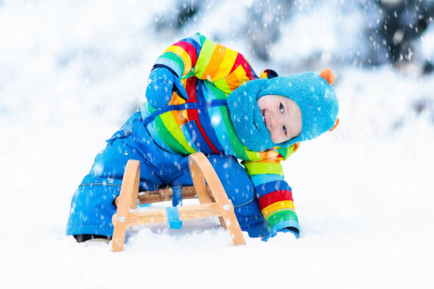 istock Boy on sleigh ride. Child sledding. Kid with sledge 861709776