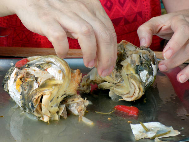 istock Woman cleaned boiled fish heads for fish soup 861726062
