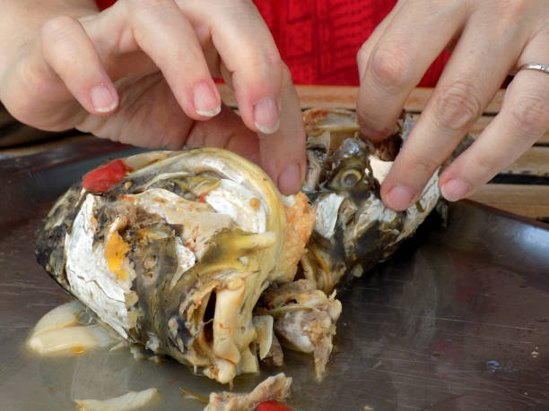istock Woman cleaned boiled fish heads for fish soup 861726072