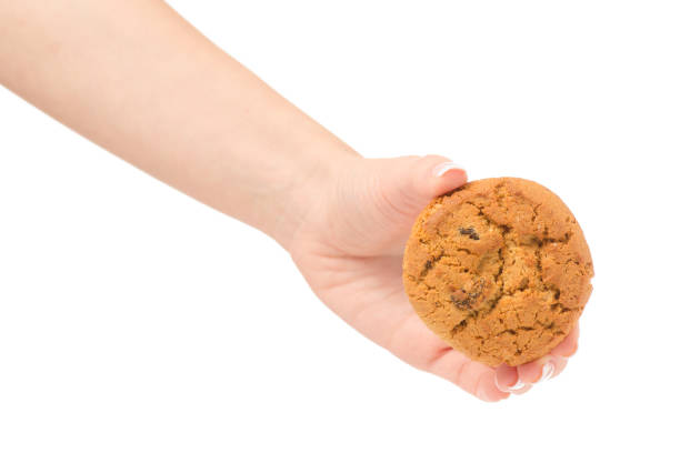 istock Female hand holding cookies with raisins isolated 861726344
