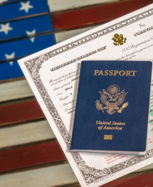 istock USA passport and naturalization certificate over US Flag 861732456