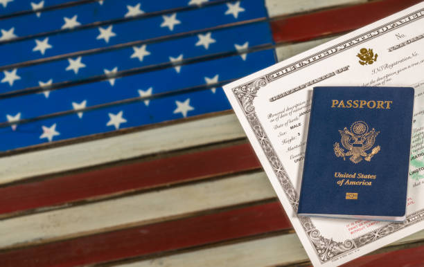 istock USA passport and naturalization certificate over US Flag 861732626