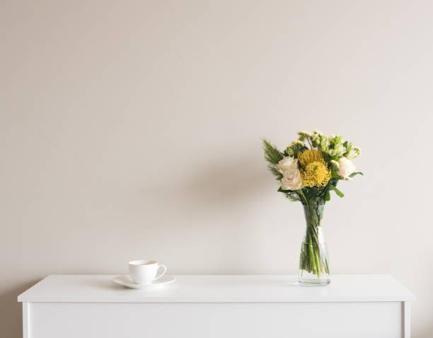 istock Flowers in vase with cup and saucer on sideboard 861749122
