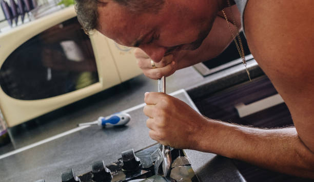 istock Man repairing broken stove 861752270