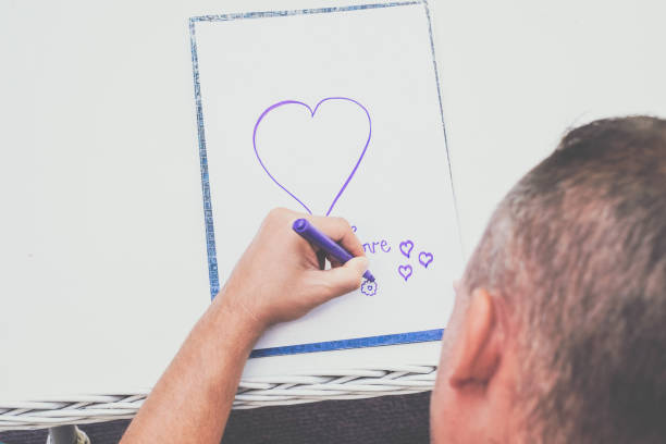 istock High angle view of man drawing hart shape 861752368