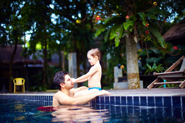 istock father and son enjoy relaxing in the pool at quiet getaway 861756252