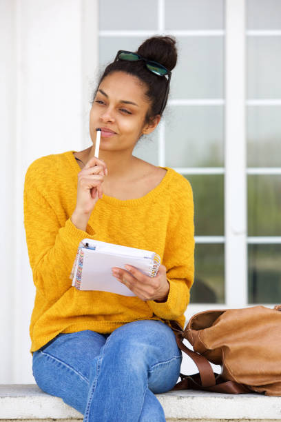 istock Thoughtful woman sitting outside with book 861761526