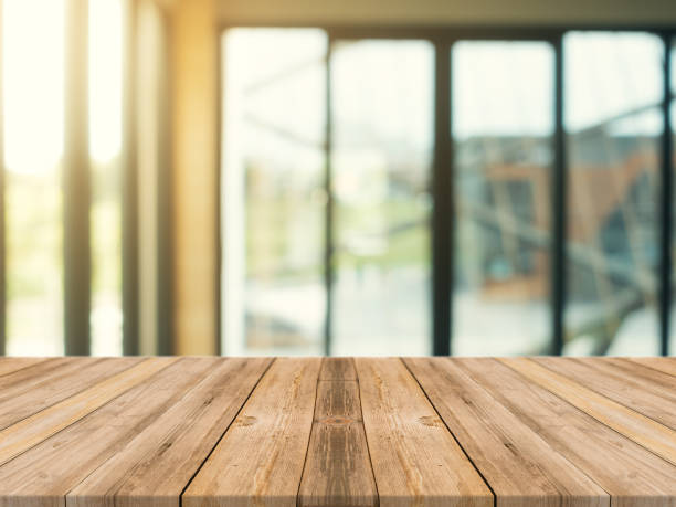 istock Wooden board empty table top on of blurred background. Perspective brown wood table over blur in coffee shop background - can be used mock up for montage products display or design key visual layout. 861762066