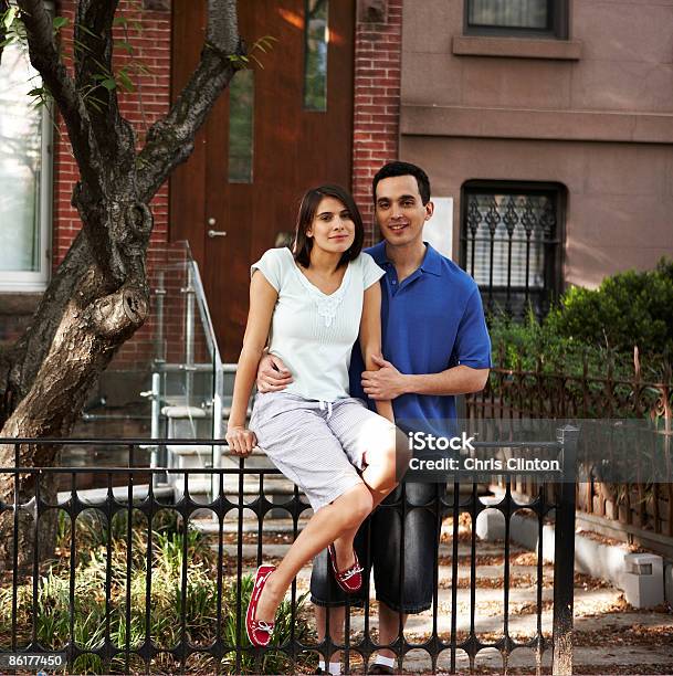 Couple In Front Of Rowhouse Stock Photo - Download Image Now - 25-29 Years, 30-34 Years, Adults Only