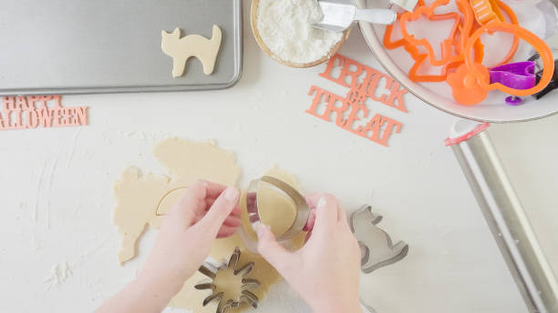 istock Mother and daughter maaking Halloween sugar cookies. 861783182