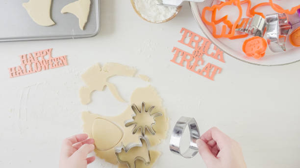 istock Mother and daughter maaking Halloween sugar cookies. 861783208