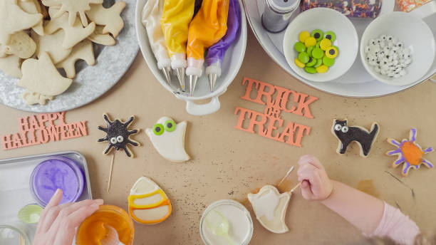 istock Mother and daughter decorating Halloween sugar cookies 861783272