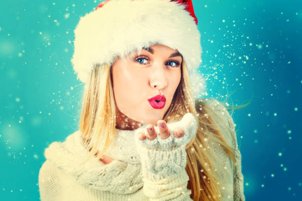 istock Happy young woman blowing snow 861791588