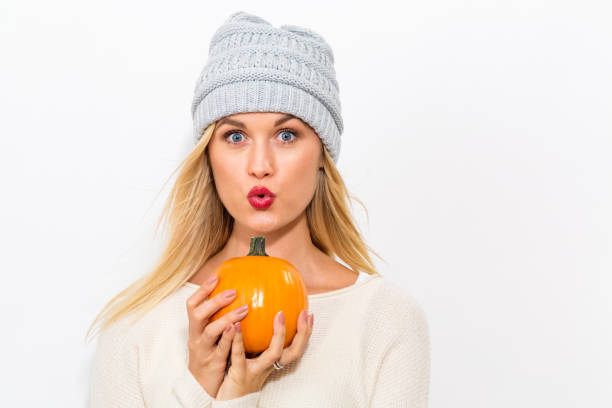 istock Young woman holding pumpkins 861791808
