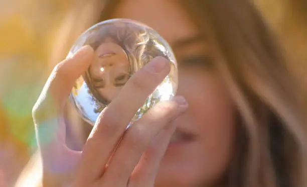 Woman looking into glass ball